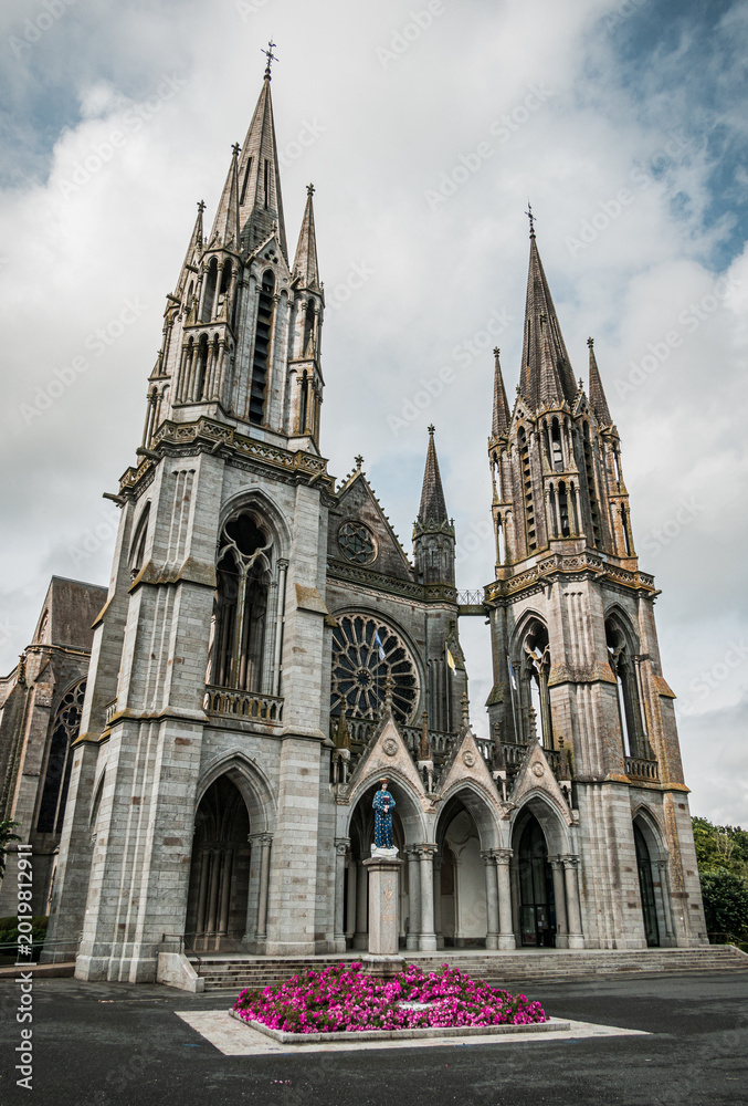 Fototapeta premium Forecourt of the Basilica with a sculpture of Virgin Mary in Pontmain, Mayenne department - France