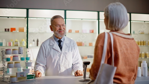 Customer displaying smartphone pharmacist closeup. Shopper requesting pills