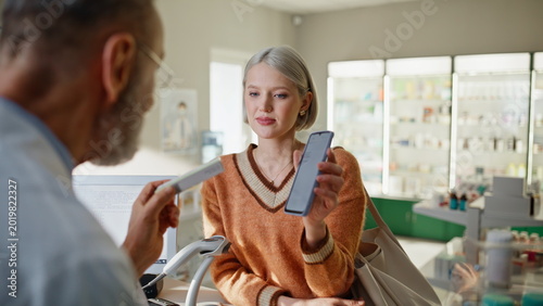 Photos Pharmacy worker proposing pills on cashier closeup