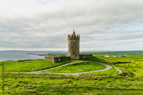 Doonagore Castle overlooking the Atlantic Ocean near Doolin, County Clare, Ireland. Historic 16th century tower house on the Wild Atlantic Way.