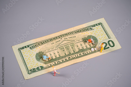 Принти на полотні Miniature figures interact on a twenty dollar bill placed on a flat surface