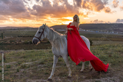 Konstfotografi Woman horse sunset riding graceful blonde female on white steed across meadow du