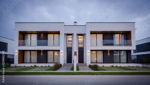 Bilde på lerret Modern white townhouses duplex exterior at dusk with clean design real estate to