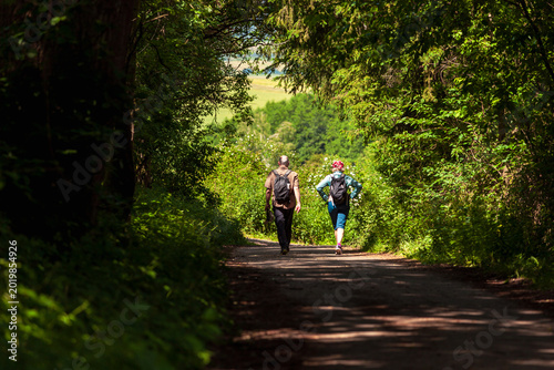 young couple walking in the woods. Hike through the forest