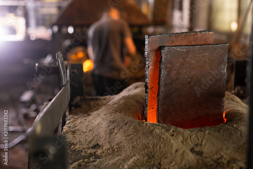 Foto Ferrous metal billet is melted in an induction furnace closeup