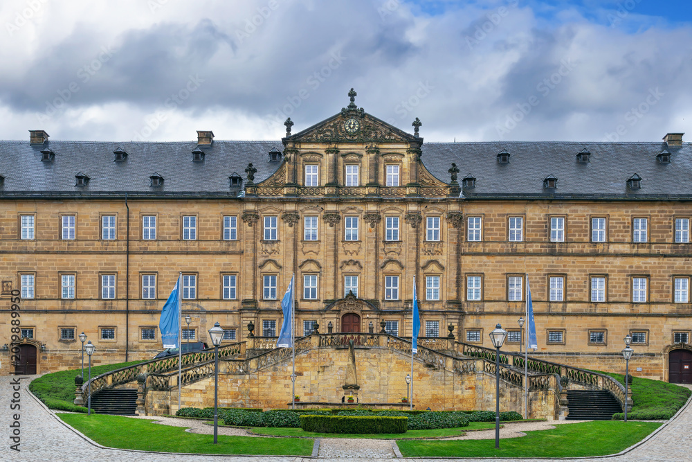 Fototapeta premium Banz Abbey in Bad Staffelstein, Germany. View of the historic baroque monastery building facade. Overcast cloudy day