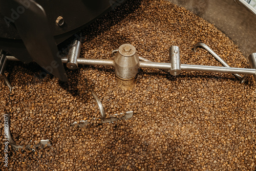 Quadro su tela High-angle shot of freshly roasted coffee beans in a professional cooling drum