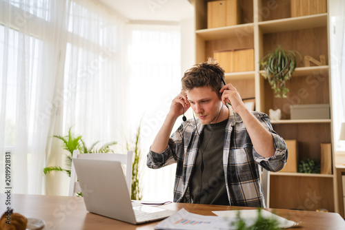 Photos Young man preparing for remote work video call