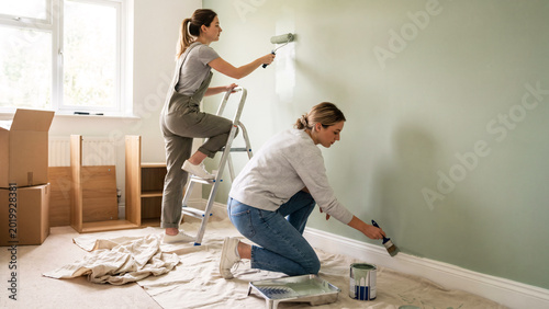 Young Lesbian Couple Painting Bedroom Accent Wall in Newly Purchased Home, First-Time Home Buyers, Home Renovation, DIY, Same-Sex Couple, LGBTQ Homeowners