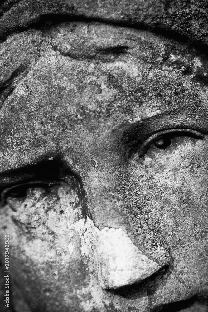 Fototapeta premium Close up of Virgin Mary stone statue with emotional expression