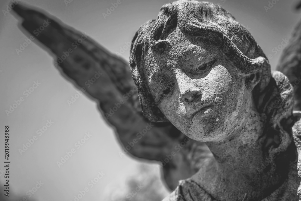 Fototapeta premium Close up wonderful guardian angel. Fragment of an ancient stone statue.