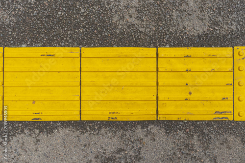 Tableau sur toile Yellow and grey floor tiles on the street. Floor tiles pattern.