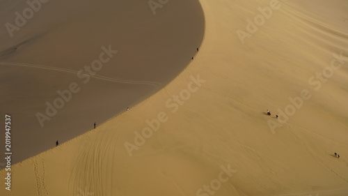 Aerial View of People Walking on Desert Sand Dunes