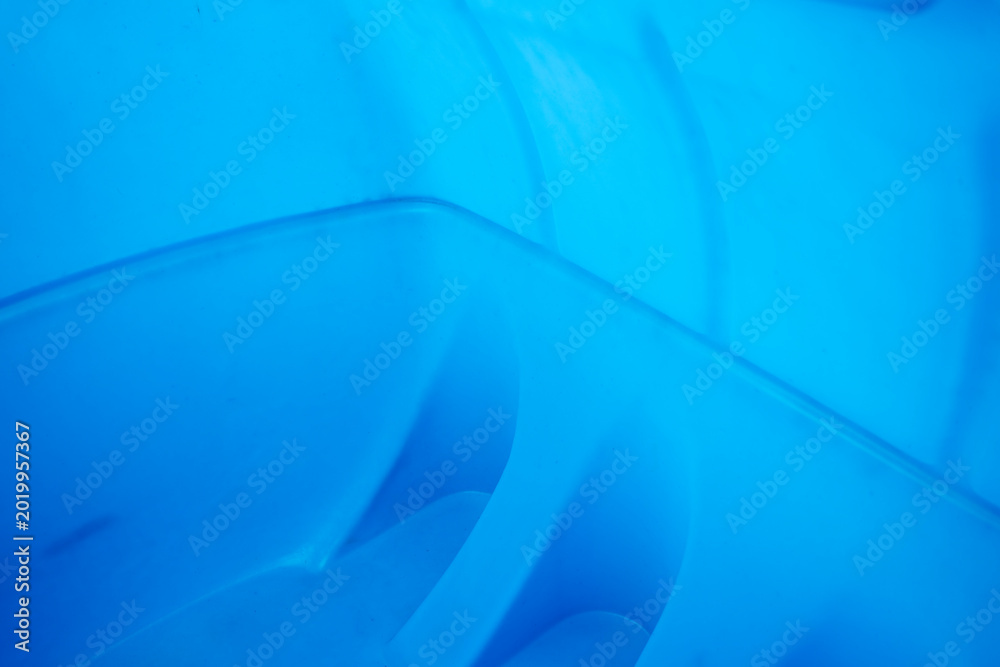 Naklejka premium Close up of blue plastic water tank interior with curved molded walls, showing empty storage container surface and abstract texture.