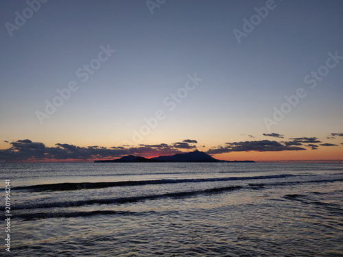 Konstfotografi Deep crimson and purple afterglow over Procida island silhouette from Bacoli bea