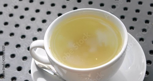 Hot ginger tea and the reflection of the sky in it in the morning. Good morning. Vigor and health.