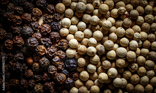 Fotografie Mixed black and white peppercorns close-up Macro, Dried whole spice texture back