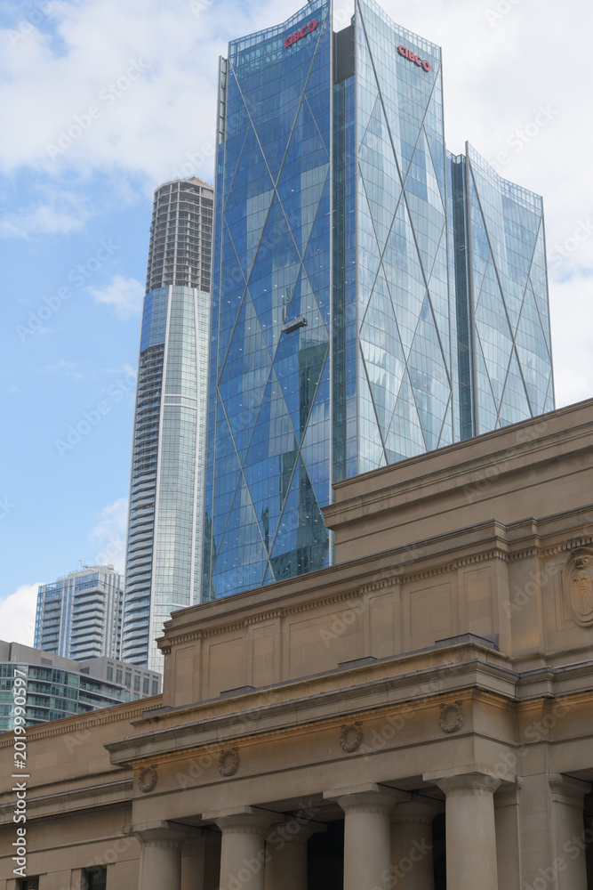 Fototapeta premium contrast of historic Union Station and CIBC Square, designed by WilkinsonEyre + Adamson Associates, headquarters of Canadian Imperial Bank of Commerce, looking southeast from Front St W, Toronto