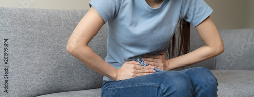 close up woman suffering stomach pain from food poisoning.