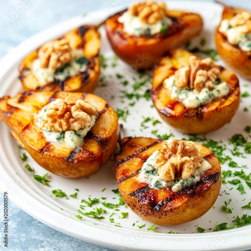 Grilled Peaches Filled With Cheese and Walnuts Served on a Platter With Herbs...