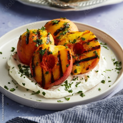 Fresh Grilled Peaches Served on a Plate With Yogurt and Herbs During a Summer...
