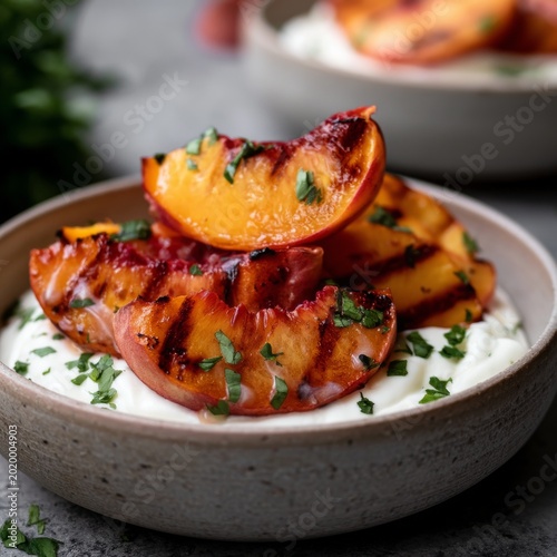 Grilled Peaches on Yogurt With Herbs in a Bowl During a Summer Afternoon