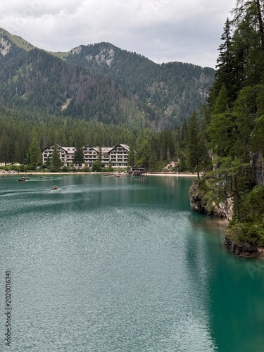 Historic Hotel Lago di Braies on the shore of the turquoise lake with mountain panorama, Dolomites, Italy