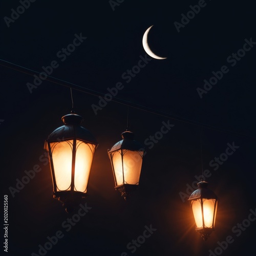 Hanging Lanterns Shine in the Night With a Crescent Moon Above