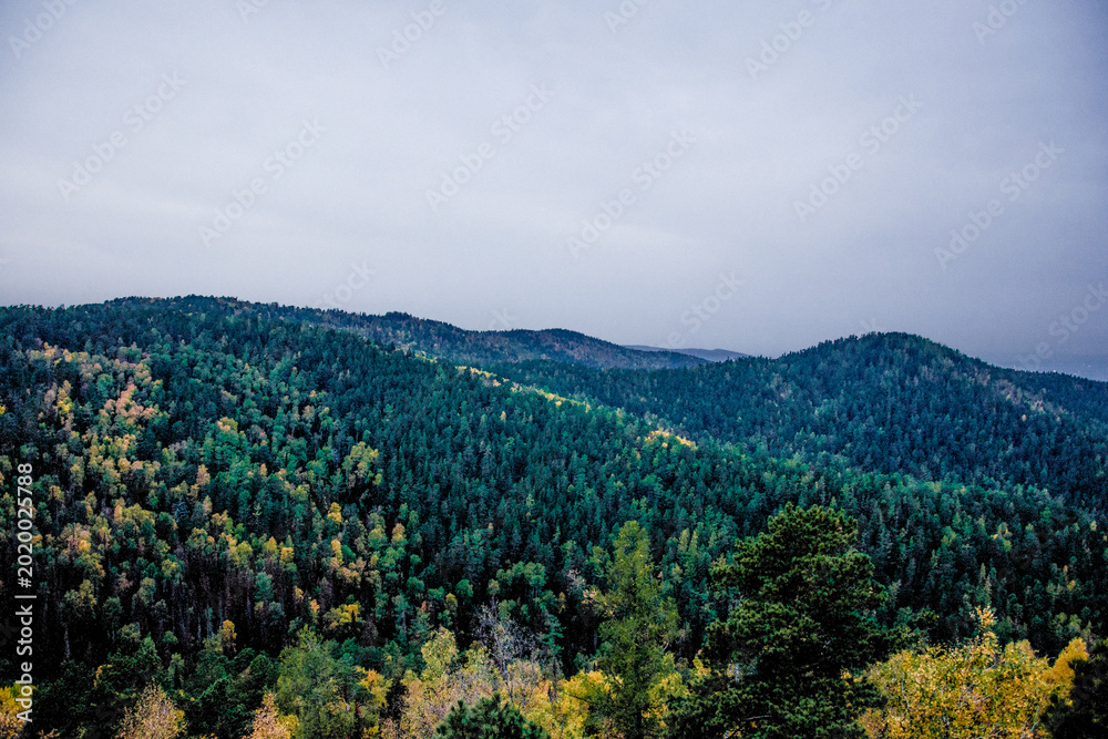 Obraz premium Landscape of snowy Siberia Krasnoyarsk mountains, mountain range in haze summer