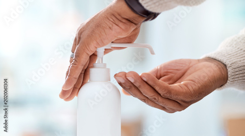 Person  hands or sanitizer with dispenser in clinic for disinfection  bacteria or germ removal. Closeup  patient or hygiene with bottle or container for healthcare safety  security or protection