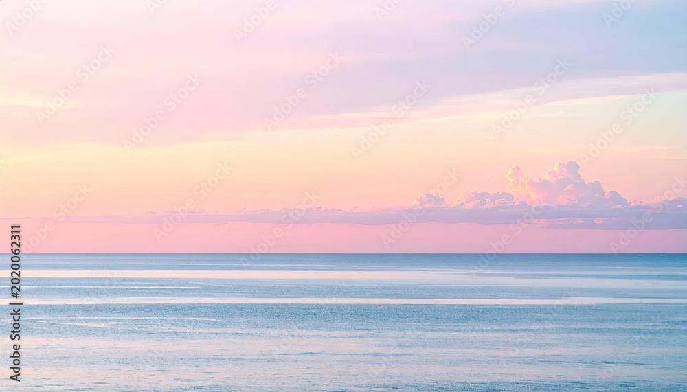 Obraz premium Tranquil ocean view with a pastel sunset sky serene coastal horizon