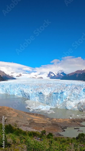 Wide angle view of the Perito Moreno Glacier ice wall and surrounding mountains near Lago Argentino in Los Glaciares National Park, Patagonia, Argentina.