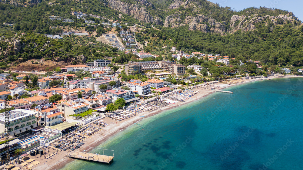 Obraz premium Turunch, Turkey - May 10, 2026: Aerial drone view of Turunç Bay, a popular coastal village near Marmaris in Muğla Province, Turkey.