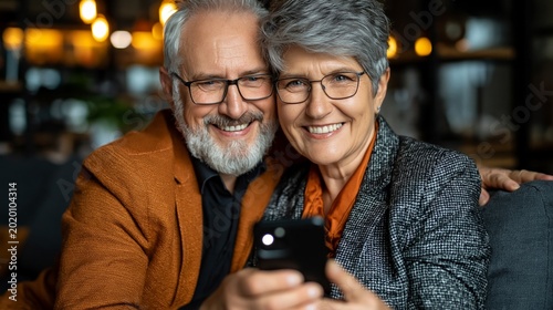 A happy elderly couple taking a selfie on a smartphone — a heart-warming backdrop to themes of digital literacy, active ageing and family values.