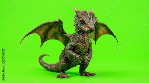 Adorable Dragon Figurine on Green Screen for Fantasy and Mythical Projects.