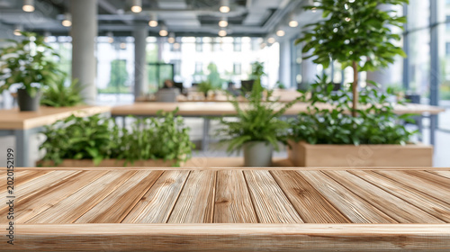 A modern office space with a wooden table and lush green plants in the background