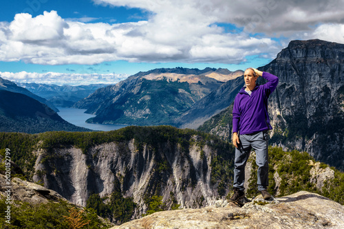 Puzzled hiker standing on a viewpoint overlooking the turquoise Lake Frey and Cerro Constitucion in Nahuel Huapi National Park.