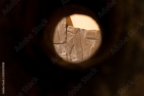 Close‑Up View Through a Circular Opening Towards a Textured Stone Surface