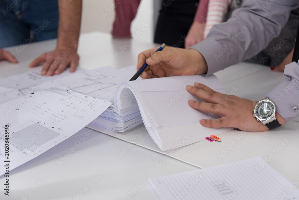 Φωτογραφία Close-up of Architect Hands Reviewing Technical Documentation and Blueprints