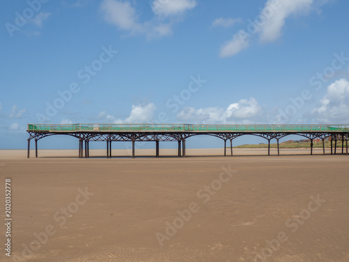 the historic pier on the beach at st Annes in Lancashire in bright summer sunlight