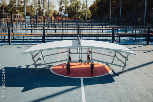 A professional Teqball table with its signature curved surface positioned on a blue and orange outdoor sports court at the VDNH Urban Park in Kyiv, Ukraine