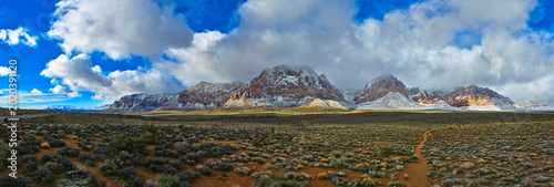 Schilderij op canvas Aerial Panorama Snow Covered Red Rock Mountains and Desert Landscape Nevada