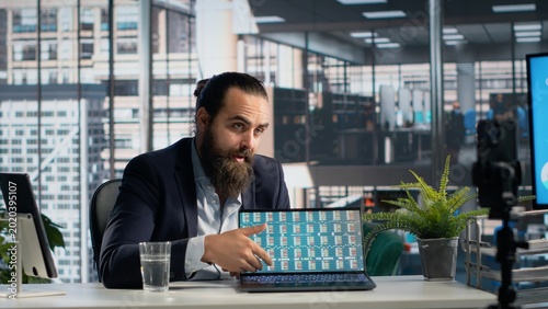 Male professional uses company data for live coaching webinar  presenting and analyzing KPIs during online courses for business education. Financial management and decision making skills in office.