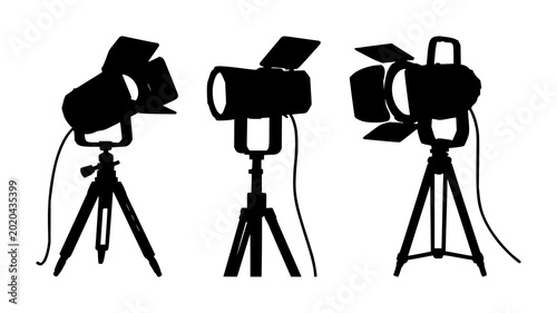 Принти на полотні Vintage theatrical spotlight set with solid black silhouette on tripod, film noi