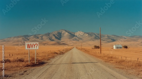 Dirt road leads to mountains with a large sign asking why
