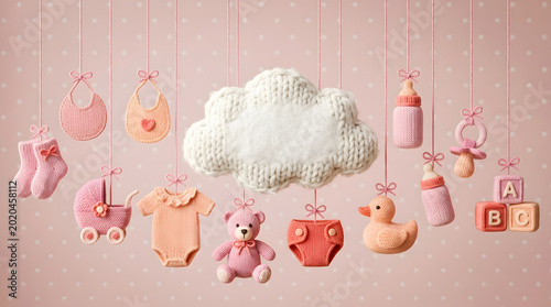 Baby girl celebration with knitted wool items on pink background