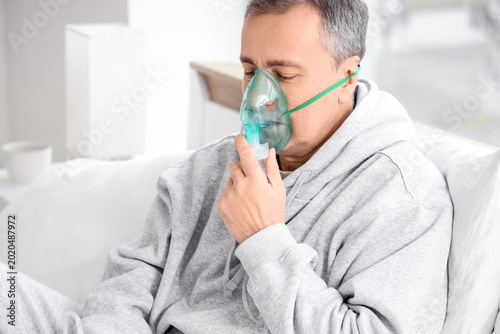 Mature man using nebulizer ...