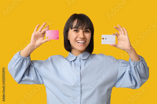 Happy young woman with cred...