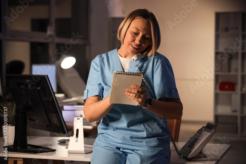 Female nurse with notebook ...