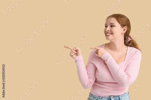 Smiling young redhead woman...